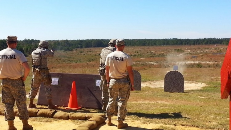 military personal dressed in uniform shooting at stationary targets