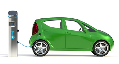 Green EV car charging at a charging station